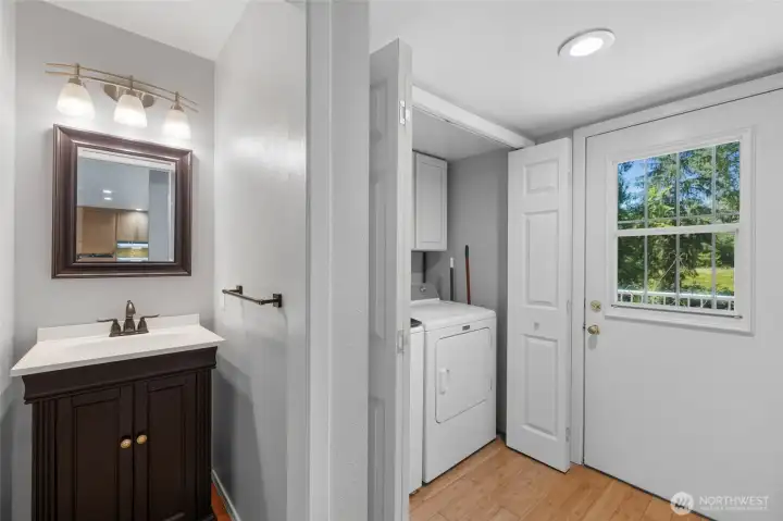 Half bathroom, laundry and door to the deck