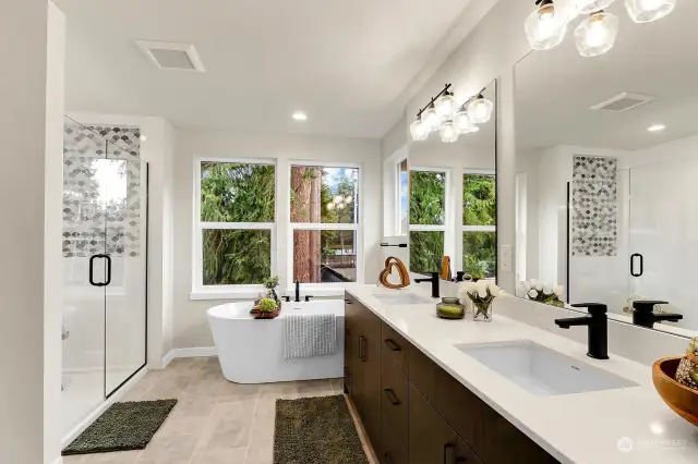 Primary bath with beautiful appointments including large, tiled shower, soaking tub, and double vanity.