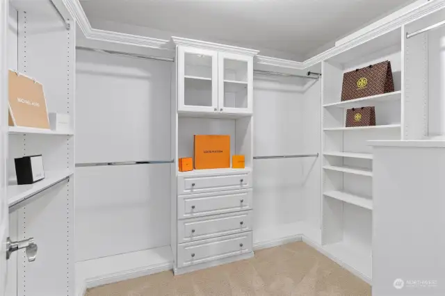 Your walk-in closet has been upgraded with a customized closet system, including a jewelry drawer, sliding belt/tie tracks & shoe racks. This space has been meticulously crafted to keep your wardrobe impeccably organized & easily accessible. The hanging rods & shelves are rearrangeable to adjust to your preferences.