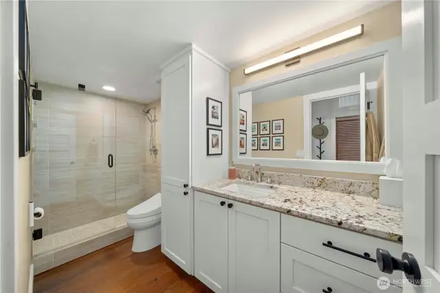 Second bath with custom cabinets and granite counters.