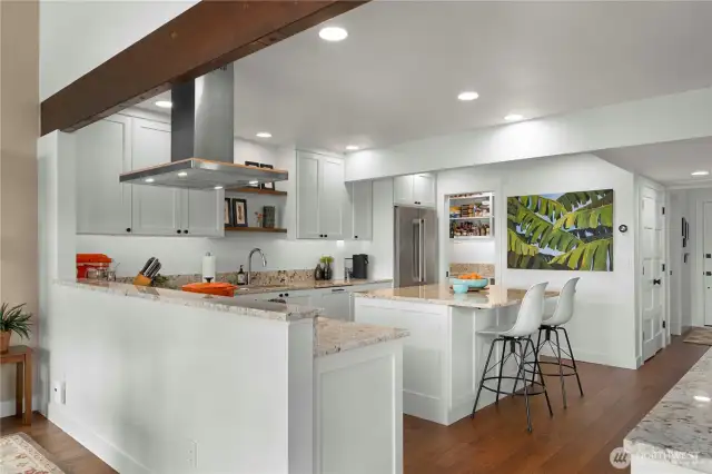 Beautiful kitchen with consistent flooring throughout condo.