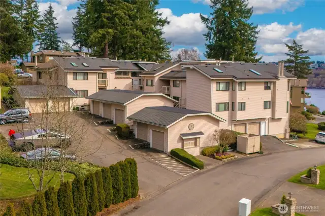 Building with garage and designated parking space to the left.
