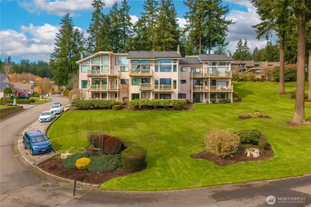 Enjoy grassy lawn area maintained by HOA, plus several guest parking spots on the left.