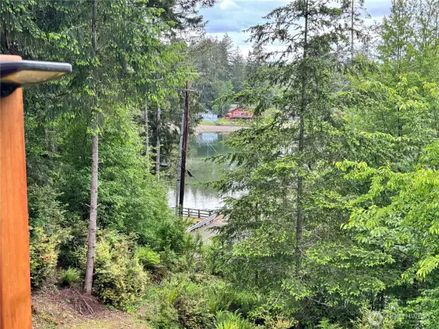 Water views from deck, dining table, kitchen and primary BR