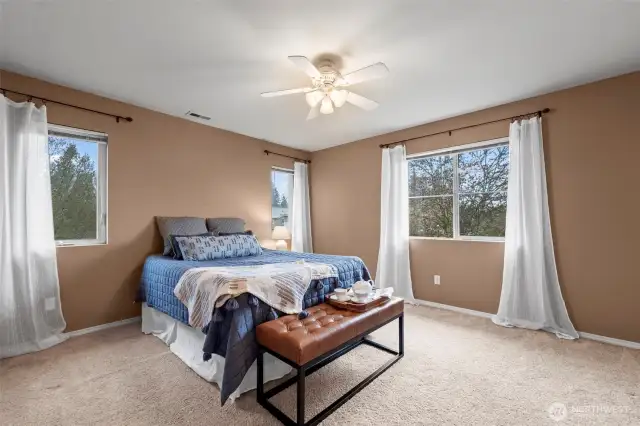Spacious primary Bedroom with ample amount of natural light flooding in.