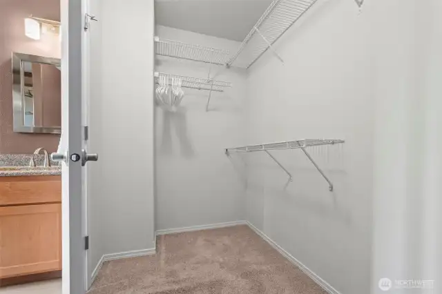 Spacious walk-in closet off of primary bathroom.