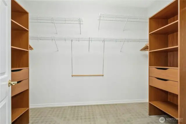 A lovely walk-in closet with organizers.
