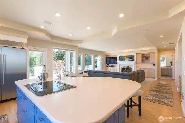 The island is open to another living area with fireplace, perfect for entertaining