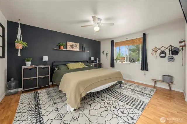 Generous primary bedroom continues with hardwood floors.