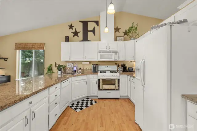 Light and bright open kitchen offer loads of cabinets and counterspace.