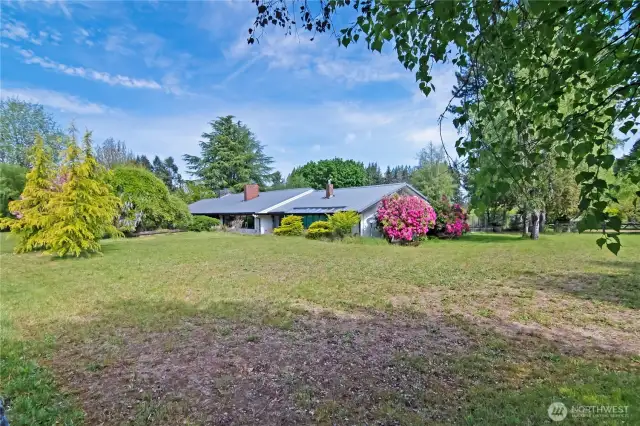 Side view of home, from the South East view, lots of mature trees and landscaping!