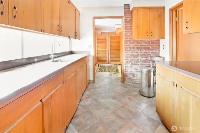 Butler's pantry through to kitchen, and side door to grand living room, mahogany throughout the home