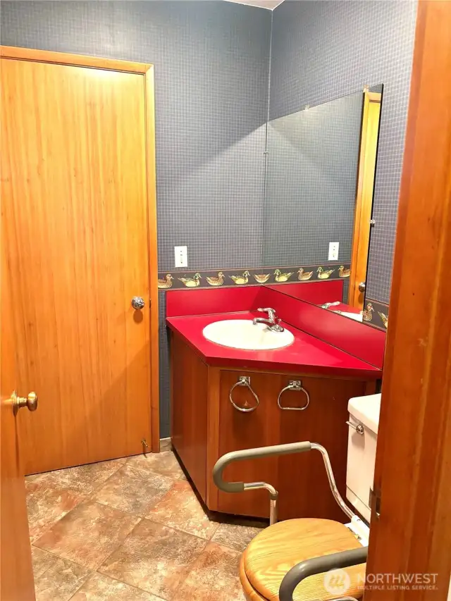 half bath off of side entrance and next to laundry room