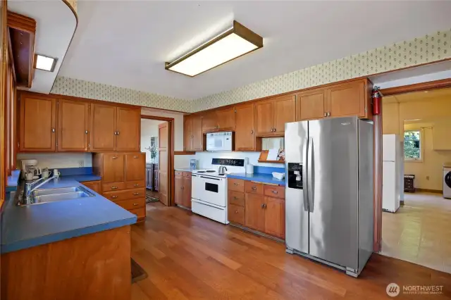 New dishwasher, refrigerator, and microwave (not yet installed, still in box). The doorway on the right leads to a massive utility, laundry, and pantry room. Secondary refrigerator conveys with the property, as do all other appliances.