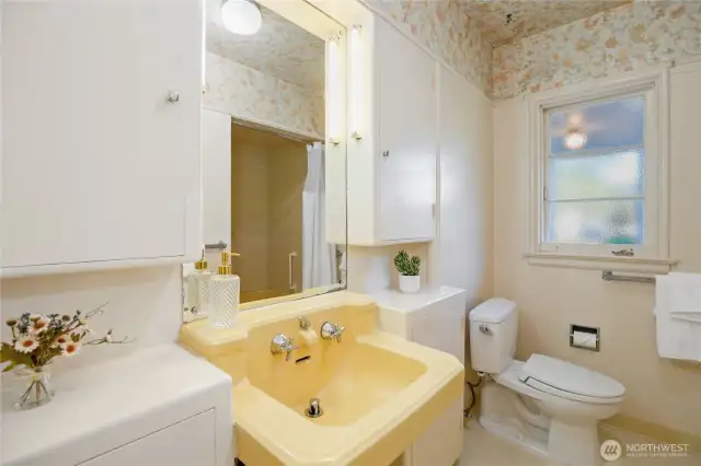 Primary ensuite with period fixtures, a garden tub and shower.