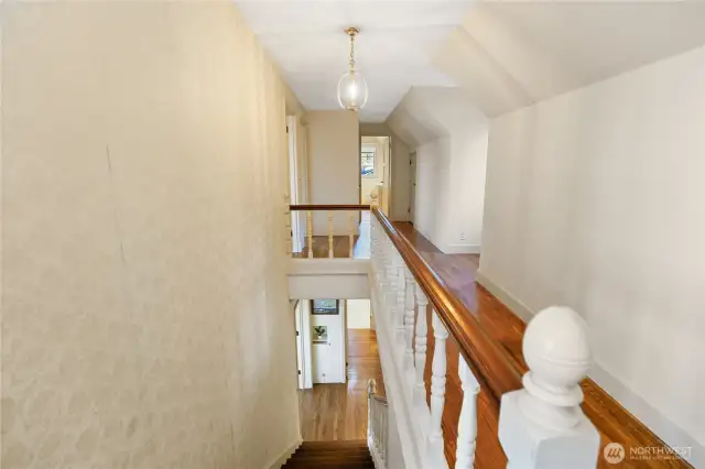 Original hardwood floors lead you upstairs to three bedrooms, a main bathroom, and finished attic space.