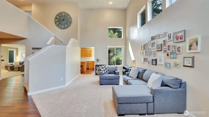 Enter to this bright and airy living space with soaring ceilings and a seamless flow into the kitchen and adjacent rooms.