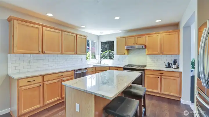 Spacious kitchen with sleek subway tile backsplash, and a central island perfect for meal prep or casual dining.