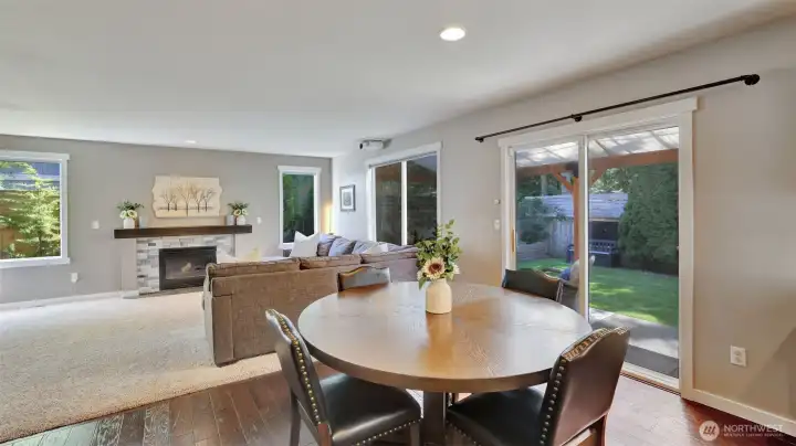 Charming dining area with beautiful engineered wood floors and abundant natural light, creating the perfect space for everyday meals or gatherings.