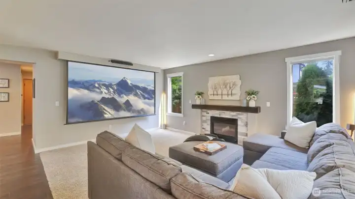 You will love having the option for a wall mounted TV or enjoying a movie at home on the projector in this versatile living room, plus this projector stays!