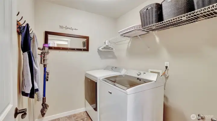 The spacious main level utility room is plumbed for a sink, offers shelving for easy storage and space for your things as you come home.