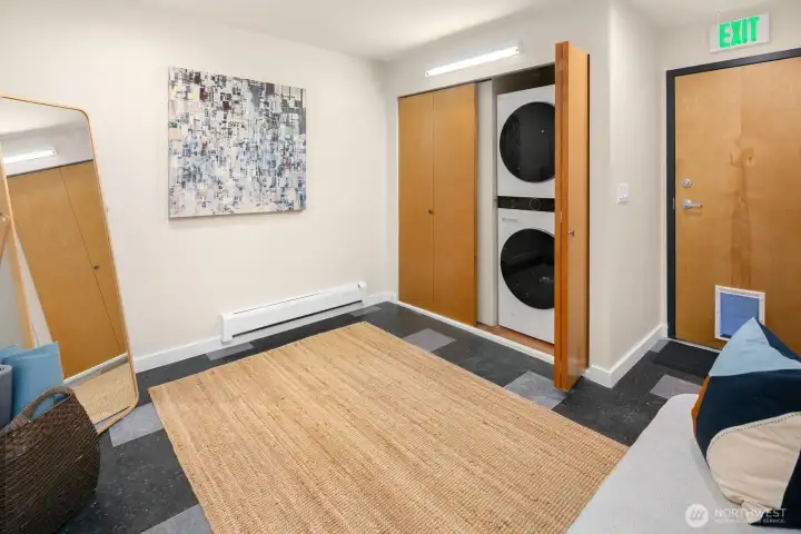 Large laundry room with doggie door for exit into a fenced side yard with outdoor shed.
