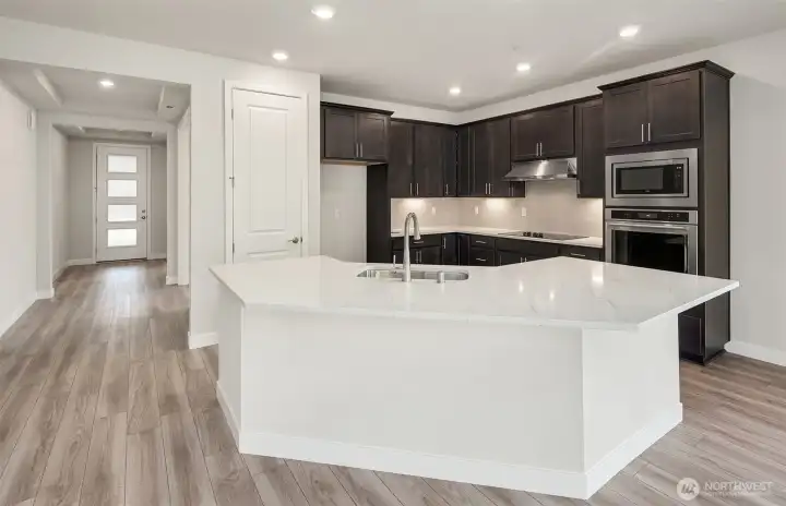 Kitchen finishes vary per home. Photo of same design, not this specific house.