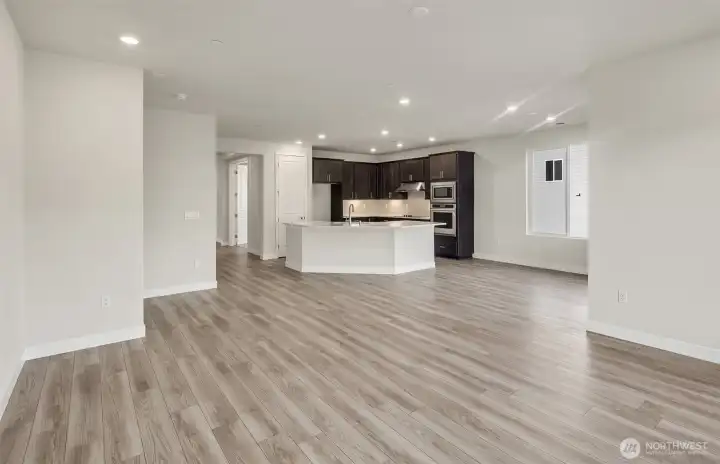 Spacious living room. Kitchen finishes vary per home. Photo of same design, not this specific house.