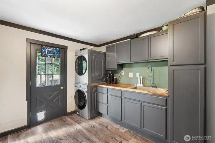 Utility room with sink and cabinets