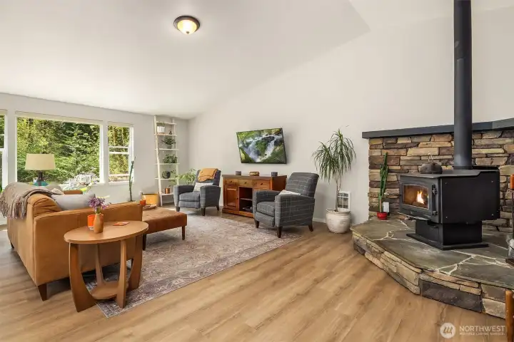 A private office and versatile bonus room add flexibility, while the freestanding wood-burning stove creates warmth and charm in the main living area.