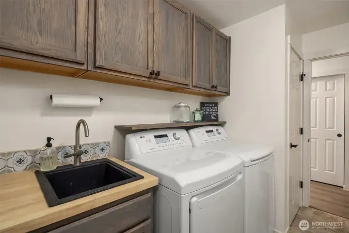 Laundry Room with utility sink and cabinetry.