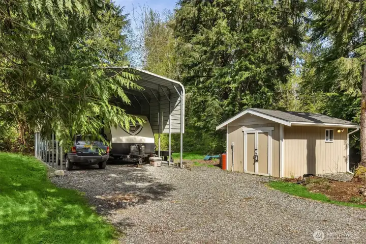 2+ Large Garage with Built-in's plus a 4+ covered parking. Well house to the right.