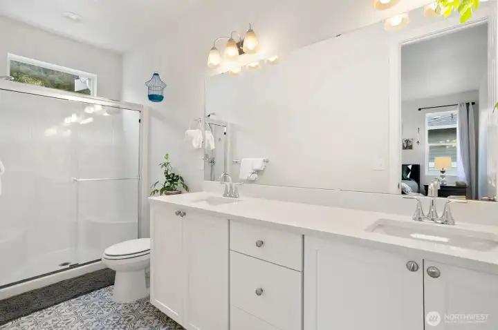 Spacious primary bathroom with designer tile floors. Spacious primary bathroom with designer tile floors.