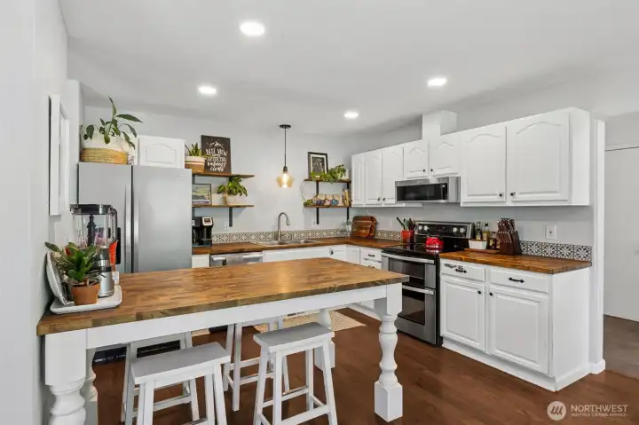 Country cozy kitchen with butcher block island is a perfect gathering spot Country cozy kitchen with butcher block island is a perfect gathering spot