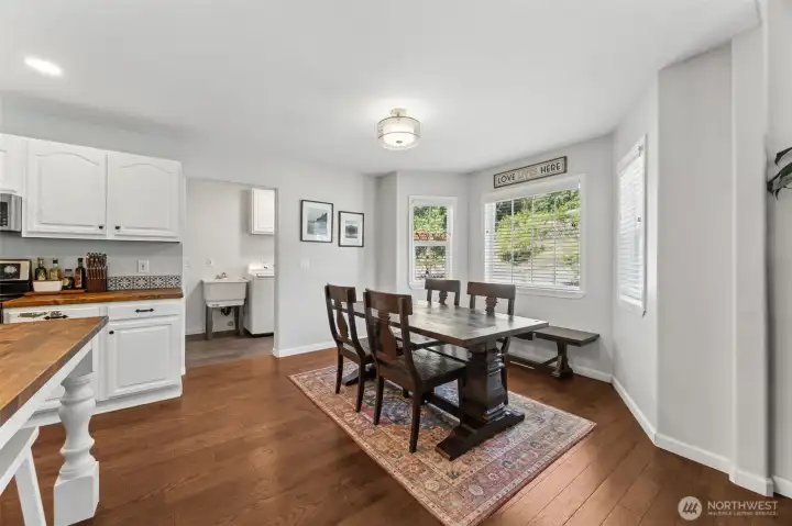 Just beyond the dining room and kitchen is the utility room, porch door, pantry, and garage access Just beyond the dining room and kitchen is the utility room, porch door, pantry, and garage access