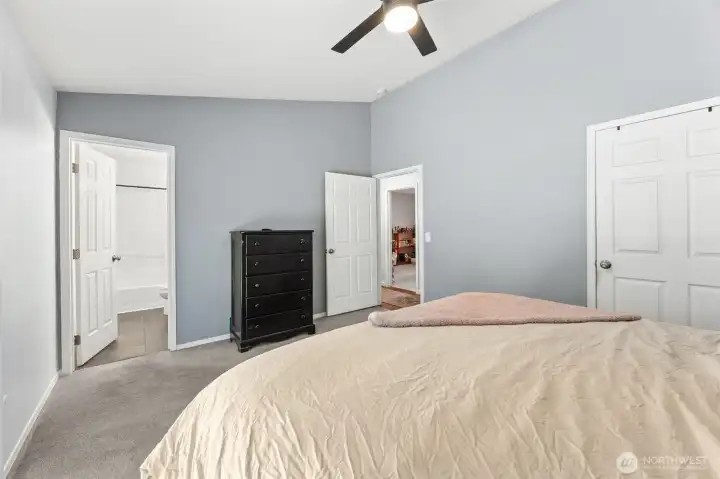 Vaulted ceilings and fan lead to full primary bath Vaulted ceilings and fan lead to full primary bath