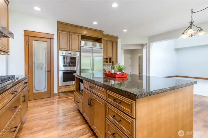 Expansive kitchen island providing generous prep space and ample additional storage.