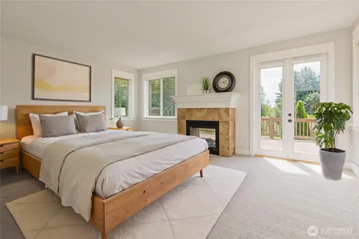Generous primary suite featuring a cozy double-sided gas fireplace and elegant French doors that open to an expansive, private balcony.