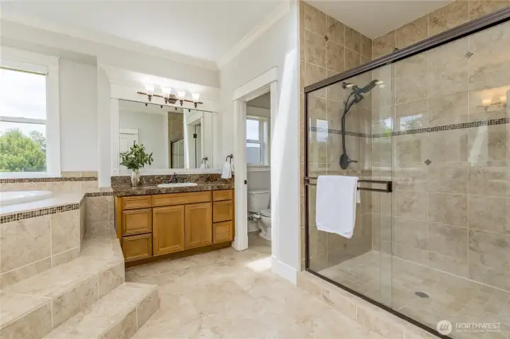 Luxurious, spa-like private bathroom featuring a spacious, beautifully tiled walk-in shower and elegant finishes for a tranquil retreat.