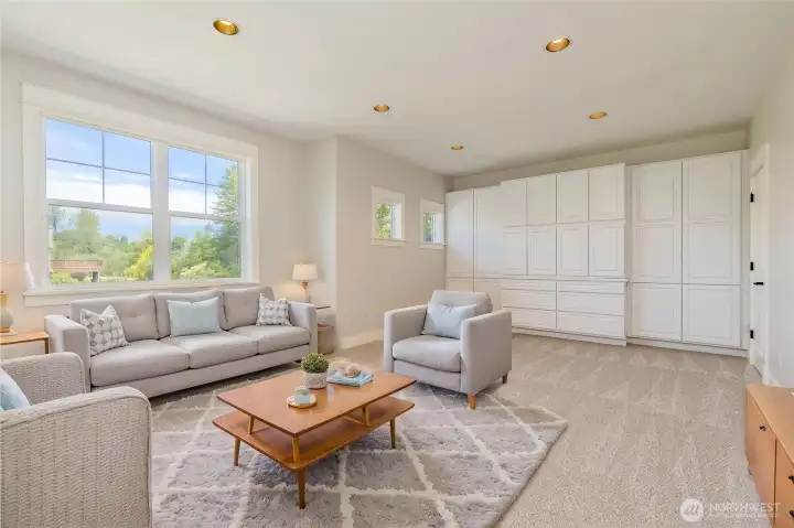 Spacious bonus room featuring extensive built-in cabinetry, abundant natural light, and the added convenience of a large walk-in closet. Perfect for a media room, play area, or secondary living space.