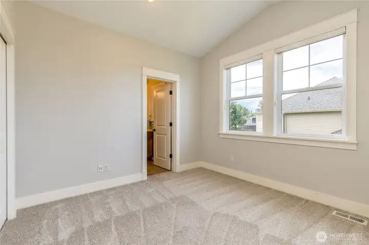 Private guest suite or secondary bedroom, featuring the convenience of an en-suite full bathroom, perfect for visitors or multi-generational living.