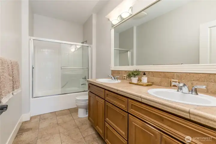 Spacious full hall bathroom, featuring dual sinks for added convenience.
