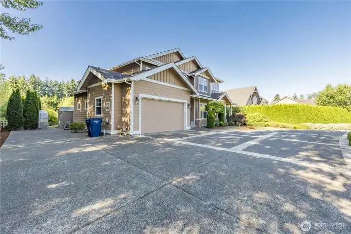 Extensive, well-maintained driveway features a spacious side extension along the east side of the home, offering excellent potential for RV or trailer parking (please verify specific storage allowances with the HOA).