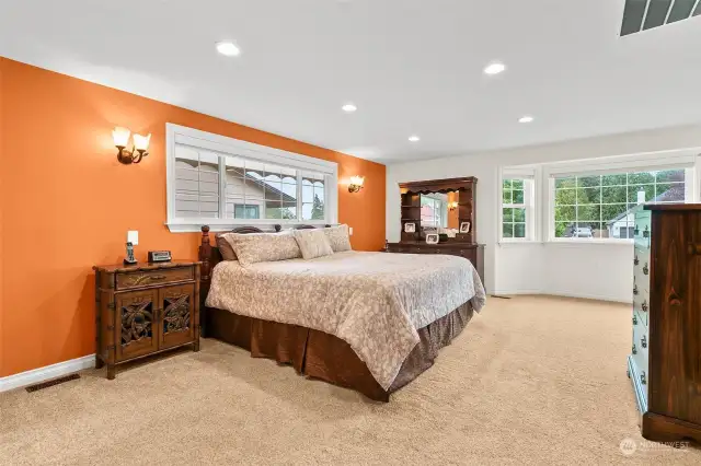 Expansive primary suite features en-suite bathroom (dual vanities, custom walk in shower, claw foot tub), large walk-in closet with custom built in shelves and drawers.  wired in sconces w/ individual dimmer switches. Beautiful bay window with corner flex space.