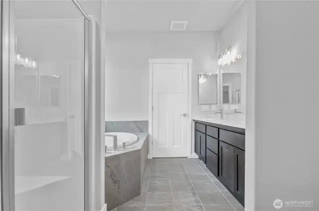 Primary bath includes an oversize soaking tub with tile flooring and tub surround.The large double vanity provides plenty of storage!