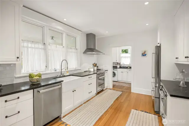 Custom cabinetry with soapstone counters and farm-style sink grace the beautiful kitchen.