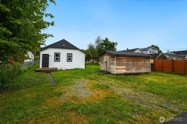 Back of the home with shed for all your gardening tools!  Parking available off the street and alley.