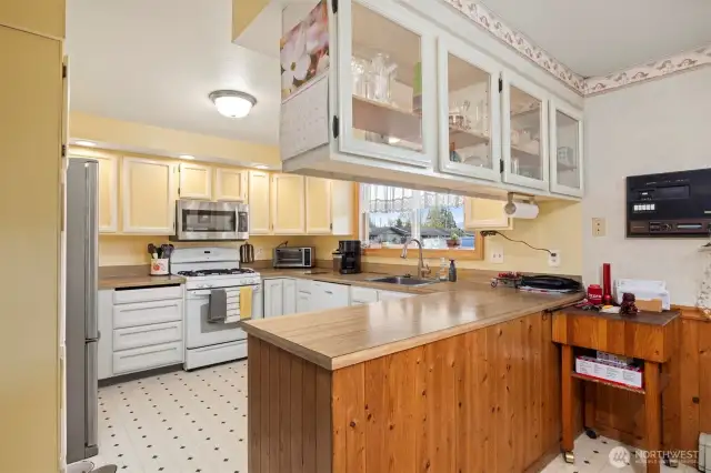 Main House: Kitchen with ample storage and display cabinets for your treasures