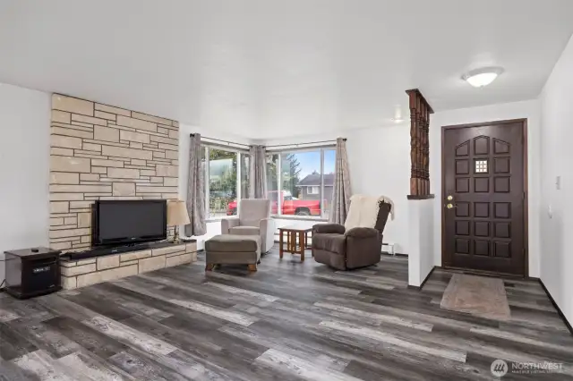 ADU has updated vinyl plank flooring and a fireplace in the living room/dining area