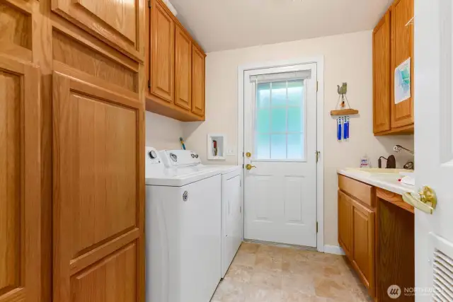 Full-size laundry room with side yard access.